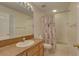 Bright bathroom features a shower-tub combo, vanity with a sink and decorative shower curtain at 29 Seagrape Cir, Clearwater, FL 33759