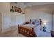 Cozy bedroom with neutral walls, ceiling fan, and comfortable Queen bed with ornate wood frame at 29 Seagrape Cir, Clearwater, FL 33759