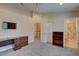 Spacious bedroom featuring neutral carpeting, a ceiling fan and an ensuite bathroom at 29 Seagrape Cir, Clearwater, FL 33759