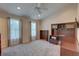 Bedroom with neutral decor featuring carpeting, built-in desk with shelves, and large windows at 29 Seagrape Cir, Clearwater, FL 33759