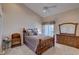 Comfortable bedroom featuring a neutral palette, ceiling fan, and comfortable bed with ornate wood frame at 29 Seagrape Cir, Clearwater, FL 33759