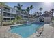 Community pool features a pool house, fenced perimeter and lounge seating at 29 Seagrape Cir, Clearwater, FL 33759