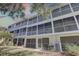 Three-story condo building with screened-in patios and lush landscaping at 29 Seagrape Cir, Clearwater, FL 33759