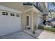 Exterior view of the townhome with a two-car garage and covered entry at 29 Seagrape Cir, Clearwater, FL 33759