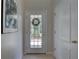 Foyer with a glass-paneled door, neutral walls, and tiled floor at 29 Seagrape Cir, Clearwater, FL 33759
