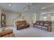 Open living room with plush carpeting, comfortable seating, and staircase at 29 Seagrape Cir, Clearwater, FL 33759