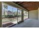 Screened patio with a view of green space and landscaping at 29 Seagrape Cir, Clearwater, FL 33759