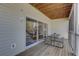 Relaxing covered patio featuring a picnic table and slider to the inside at 29 Seagrape Cir, Clearwater, FL 33759