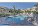 Community pool with lounge chairs surrounded by mature landscaping at 29 Seagrape Cir, Clearwater, FL 33759