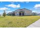 Spacious backyard featuring green grass, a screened-in patio, and partial fencing at 3113 Marine Grass Dr, Wimauma, FL 33598