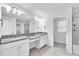 Bathroom features dual sinks with granite countertops and a large mirror at 3113 Marine Grass Dr, Wimauma, FL 33598