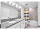 Bathroom with a granite countertop, double sinks, tile accents, and shower curtain at 3113 Marine Grass Dr, Wimauma, FL 33598