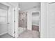 Bright bathroom with a glass shower, tile floors, and walk-in closet access at 3113 Marine Grass Dr, Wimauma, FL 33598