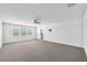 Large main bedroom with neutral carpet and large window for lots of natural light at 3113 Marine Grass Dr, Wimauma, FL 33598