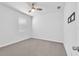 Bedroom with neutral carpet, ceiling fan, and window offering natural light at 3113 Marine Grass Dr, Wimauma, FL 33598