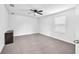 Neutral carpeted bedroom with a window and a dark wood dresser at 3113 Marine Grass Dr, Wimauma, FL 33598