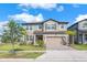 Charming two-story home with a two-car garage and beautifully landscaped front yard, perfect for suburban living at 3113 Marine Grass Dr, Wimauma, FL 33598
