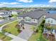 A beautiful two-story home boasts a well-manicured lawn, paver driveway and complemented by lush landscaping at 3113 Marine Grass Dr, Wimauma, FL 33598