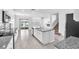 Gourmet kitchen boasting granite countertops, stainless steel appliances, and a center island with a seamless flow to the living at 3113 Marine Grass Dr, Wimauma, FL 33598