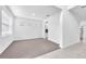 Bright living area with neutral tones and a versatile open floorplan, enhanced by plush carpet and tiled entry at 3113 Marine Grass Dr, Wimauma, FL 33598