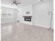 Living room with modern electric fireplace, neutral paint, tile flooring, and natural light at 3113 Marine Grass Dr, Wimauma, FL 33598