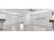 Bright living area featuring tile floors, modern fixtures, and access to backyard at 3113 Marine Grass Dr, Wimauma, FL 33598