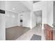 Bright living room showcasing neutral tones and a spacious open floorplan, complemented by tile and carpet flooring at 3113 Marine Grass Dr, Wimauma, FL 33598