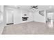 Spacious living room features an electric fireplace, tile floors and access to entryway at 3113 Marine Grass Dr, Wimauma, FL 33598
