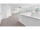 Open loft area with plush carpets, neutral decor, and plenty of natural light at 3113 Marine Grass Dr, Wimauma, FL 33598