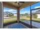 Screened patio with exterior view showcasing a well-maintained community at 3113 Marine Grass Dr, Wimauma, FL 33598