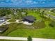 Aerial view of a community pavilion, picnic tables, and green space for outdoor gatherings and relaxation at 3113 Marine Grass Dr, Wimauma, FL 33598