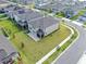 Aerial view of a home featuring a spacious backyard, screened-in patio, and beautiful neighborhood setting at 3113 Marine Grass Dr, Wimauma, FL 33598