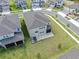 A home showcasing a large backyard with a screened-in patio, perfect for outdoor enjoyment and entertaining at 3113 Marine Grass Dr, Wimauma, FL 33598