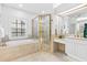 Bright bathroom with soaking tub, walk-in shower, and vanity, designed for relaxation and functionality at 3117 W Knights Ave, Tampa, FL 33611