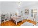 Charming bedroom featuring hardwood floors, a cozy bed, and bright windows creating a comfortable space at 3117 W Knights Ave, Tampa, FL 33611