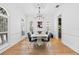 Bright dining room with hardwood floors, stylish chandelier, and modern art at 3117 W Knights Ave, Tampa, FL 33611