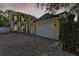 Elegant exterior with a wide driveway, a two-car garage, and architectural details at 3117 W Knights Ave, Tampa, FL 33611