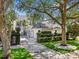 Beautiful two-story home with manicured landscaping, a brick driveway, and a three-car garage at 3117 W Knights Ave, Tampa, FL 33611