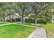 Beautiful front yard, green grass and lush manicured bushes, brick driveway, as well as a view of the home at 3117 W Knights Ave, Tampa, FL 33611