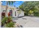 Two-story home featuring a spacious driveway, a two-car garage, and lush tropical landscaping at 3117 W Knights Ave, Tampa, FL 33611