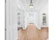 Bright and airy hallway featuring hardwood floors, white walls and trim, and recessed lighting at 3117 W Knights Ave, Tampa, FL 33611