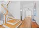 Bright hallway with hardwood floors leads to staircase and multiple rooms creating a welcoming entrance at 3117 W Knights Ave, Tampa, FL 33611