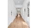 Hallway with hardwood floors, white walls and doors, and light fixtures overhead at 3117 W Knights Ave, Tampa, FL 33611