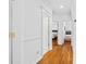 Hallway leading to bedrooms with hardwood floors and white trim details at 3117 W Knights Ave, Tampa, FL 33611