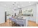 Modern eat-in kitchen with hardwood floors, granite counters, tile backsplash, and island seating at 3117 W Knights Ave, Tampa, FL 33611