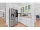 Kitchen with stainless steel refrigerator, white cabinets, and granite countertops at 3117 W Knights Ave, Tampa, FL 33611