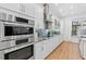 Modern kitchen featuring stainless steel appliances, white cabinets, and sleek countertops at 3117 W Knights Ave, Tampa, FL 33611