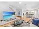Open concept living room with hardwood floors and access to modern eat-in kitchen at 3117 W Knights Ave, Tampa, FL 33611