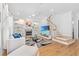 Bright living room with hardwood floors, stairs, and fireplace with built-in shelves at 3117 W Knights Ave, Tampa, FL 33611