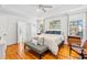Bright main bedroom with hardwood floors, ceiling fan, and artwork, creating a relaxing retreat at 3117 W Knights Ave, Tampa, FL 33611